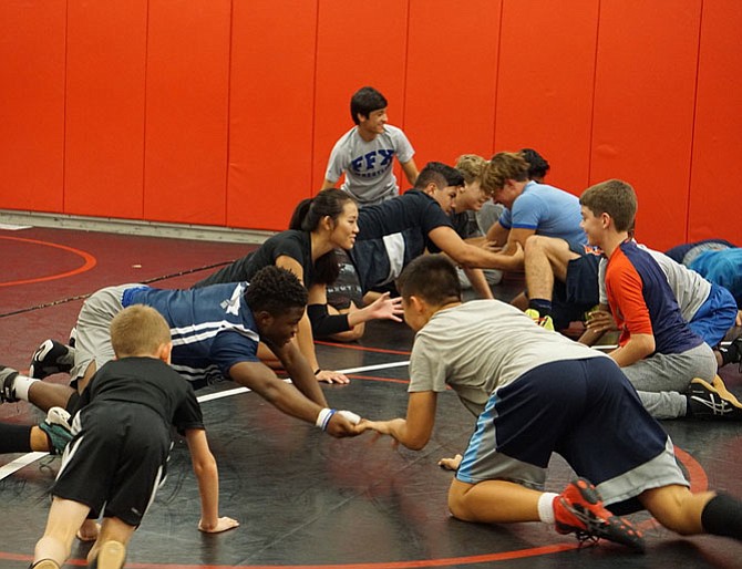 During their warmup time, NOVA wrestlers play a game to develop wrestling-specific skills.
