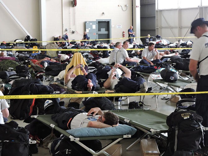 Urban search and rescue crews nationwide rest in a hangar in the heart of Georgia Friday, Sept. 8 at Robins Air Force Base prior to boarding military transport planes to Hurricane Irma disaster zones in Florida and the Caribbean.