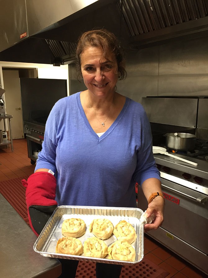 Mary Misleh holds a tray of birds nest pastries just out of the oven. Saints Peter & Paul Antiochian Orthodox Church is holding its 34th annual Middle Eastern Bazaar Sept. 22-24.