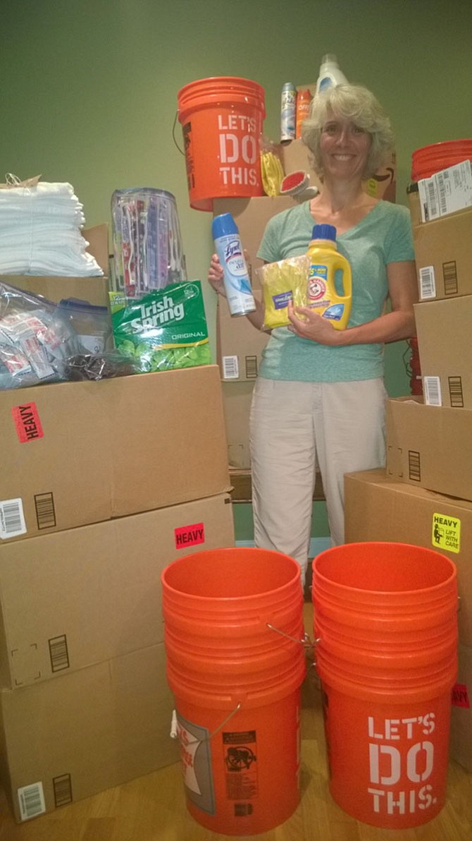 Fairfax resident Christie Johnson is knee-deep in flood buckets and up to her ears in disaster relief supplies Tuesday night as she prepares for Sunday – when her fellow churchgoers will assemble 300 personal hygiene kits and 25 cleaning buckets for the United Methodist Committee on Relief. 
