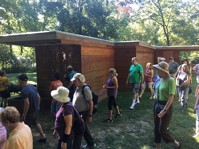 Visitors tour the grounds of the Pope-Leighey House, which was designed by Frank Lloyd Wright in Mount Vernon.