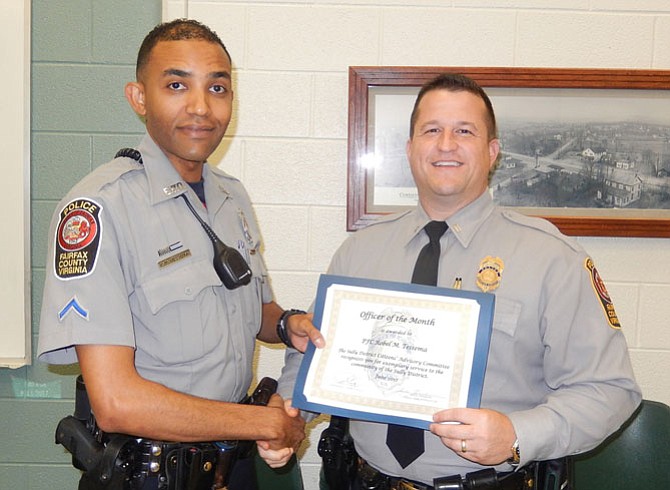 PFC Robel Tessema (left) receives his Officer of the Month certificate from the Sully District Station Assistant Commander, Lt. Ryan Morgan.
