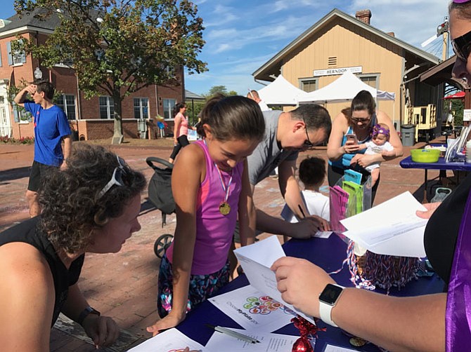 Herndon Parks & Recreation Department awarded Avalon Gallardo, 10, of Herndon a gold medal for completing all seven stations at the Family Fitness & Fun FEST held Saturday, Sept. 23 in downtown Herndon.