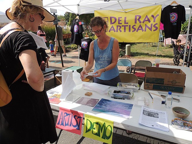 Artist Jen Nicholson leads a demonstration outside the Del Ray Artisans during last year’s Art on the Avenue. This year’s festival will take place Oct. 7.