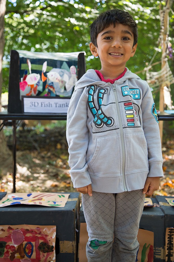 Vasav Ramineni, a 4-year-old student at Country Day Montessori School with his artwork, the 3D fish tank at the MPAartfest in McLean on Sunday, Oct. 1, 2017. 