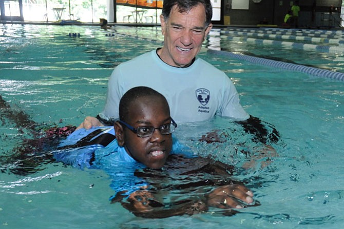 Ken Kozloff works with Sami Zachaira during an Adapted Aquatic class at Providence Rec Center.