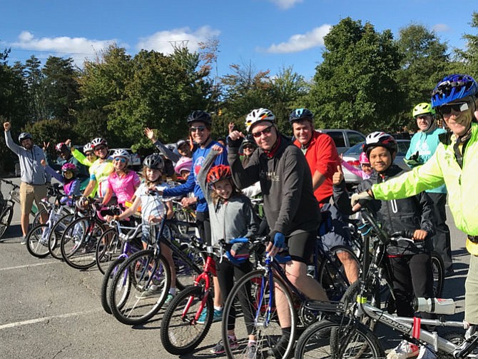 Participants in the inaugural Cupcake Bike Ride produced by Herndon Parks & Recreation let out a cheer for cycles and cupcakes as they prepare to follow the 4-mile donut-shaped loop around Herndon, stopping for treats at coffee shops and bakeries on the preplanned route.
