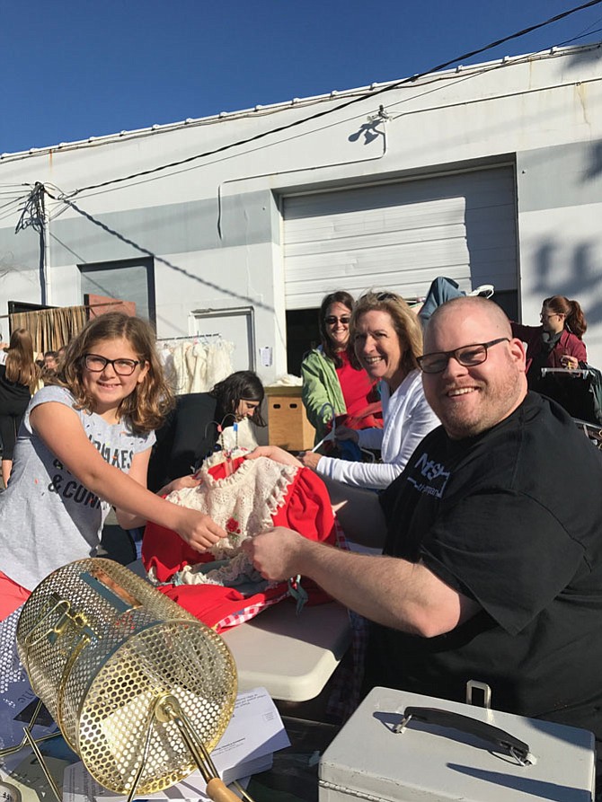 Claire Tarallo, 11, of Herndon purchases her Halloween costume from Matt C. Thompson, Managing Director, Next Stop Theatre Company, at the organization’s Costume Sale held Saturday, Sept. 30 at 750 Center St.