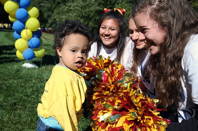 Bishop Ireton cheerleaders greet two-year-old Oliver Humes from Alexandria during the walk.
