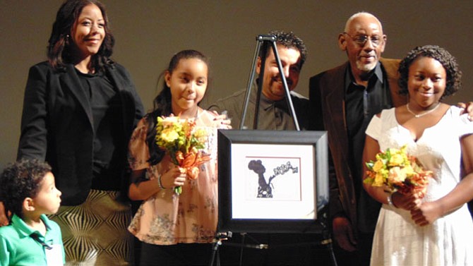 Artist Gabriela Aroche and her family with her artwork.
