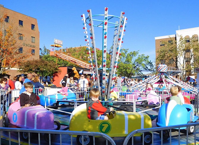Children enjoy the carnival rides at a past festival.