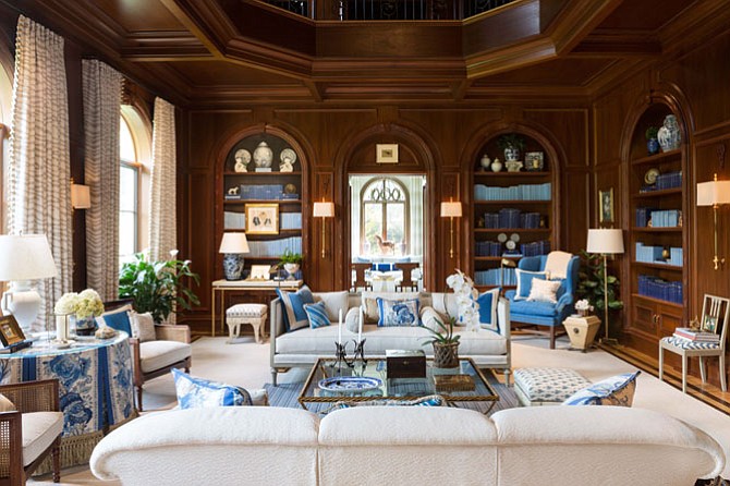 Inspired by the library of New York socialite Brooke Astor, designer Kelley Proxmire used shades of blue against dark wood in the library of the D.C. Design House.