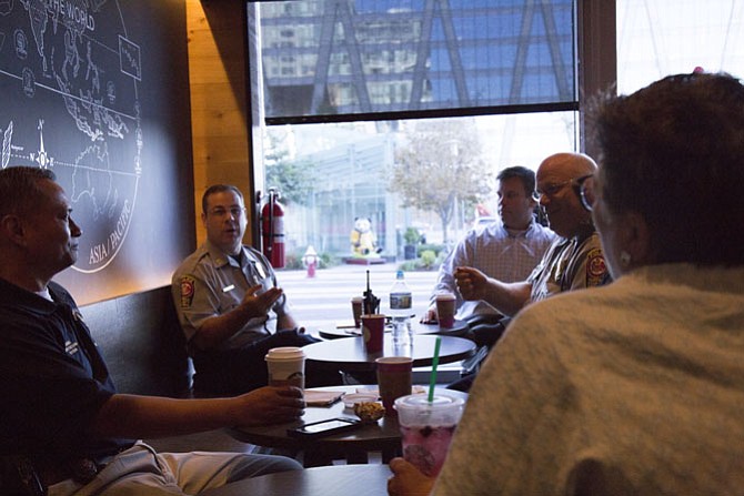 Police officers from the Fairfax County Police Department Reston District Station spoke with Maggie Parker, spokesperson for Comstock Partners, at the Starbucks at Reston Station on the morning of Wednesday, Oct. 4, during “Coffee with A Cop” day. From left: Commander Capt. Ronald Manzo, Assistant Commander Lt. Greg Malarkey, 2nd Lt. Anthony Lampe and Maggie Parker.