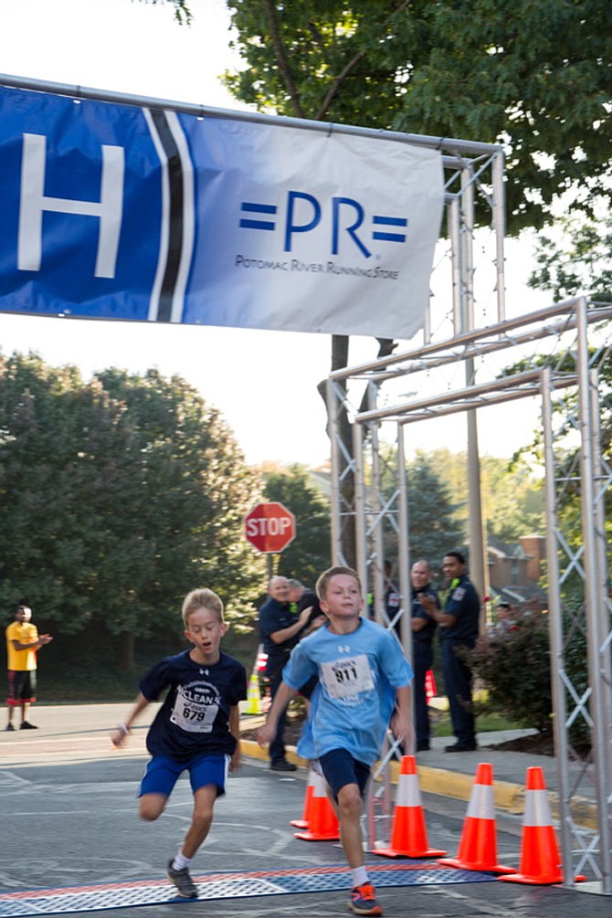 From left: Liam Welch, sixth grader at Kent Gardens, and Artus Justan, a McLean resident and fifth grader at Kent Gardens, compete for the finish at the eighth annual McLean 5K race Saturday morning, Oct. 7.