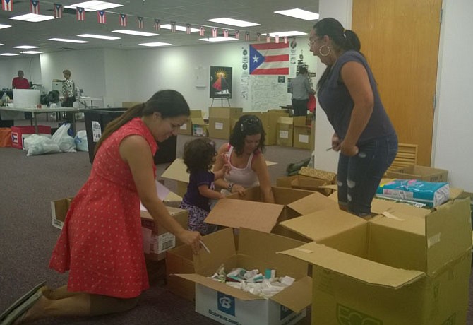 While their kids are at school on a Friday afternoon, Fairfax County mothers organize boxes of toiletries Oct. 6 before these donated supplies are shipped from the collection center at 14320-A Sullyfield Circle in Chantilly to storm survivors in Puerto Rico.