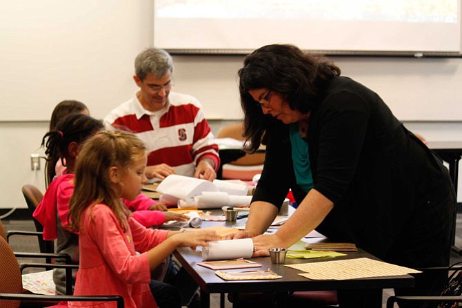 Kara L. Laughlin is a hands-on writer and shows a young crafter how to make the cover of a timeline journal from her book “Marvelous Memories: Paper Keepsake Creations” at the 2015 Fall for the Book Festival. Back by popular demand, Laughlin will lead a jewelry-making workshop Oct. 14 at 2:30 p.m. in the Old Town Hall in Fairfax at the corner of Main Street and University Drive, where she will show tween fashionistas how to “Sparkle and Shine!”