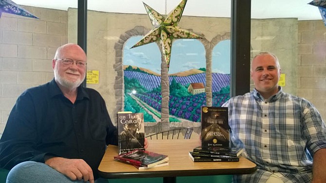 Fairfax author John B. Wren, left, and Springfield writer Eric Gardner, right, discuss the upcoming fall book season Aug. 23 at the Grounded Coffee Shop in Alexandria, where they meet weekly as a mutual sounding board and keep each other motivated to write.