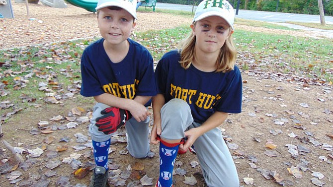 Michael Erlandson and friend Abby Beddis show off the socks that Michael designed.