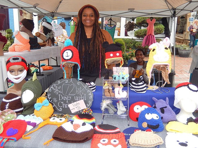 Andrea Scott of N the Loop sells handmade, crocheted caps, scarves and ponchos. Seated is Tanisha Nicholson.