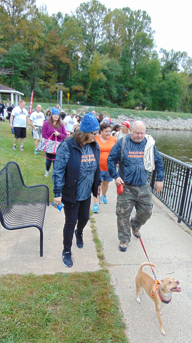 Participants walk the path around Lake Accotink in Springfield during the fifth-annual, two-mile Fall Walk, which raised about $82,000 for the Hemophilia Association of the Capital Area (HACA) on Saturday, Oct. 14, 2017. 

