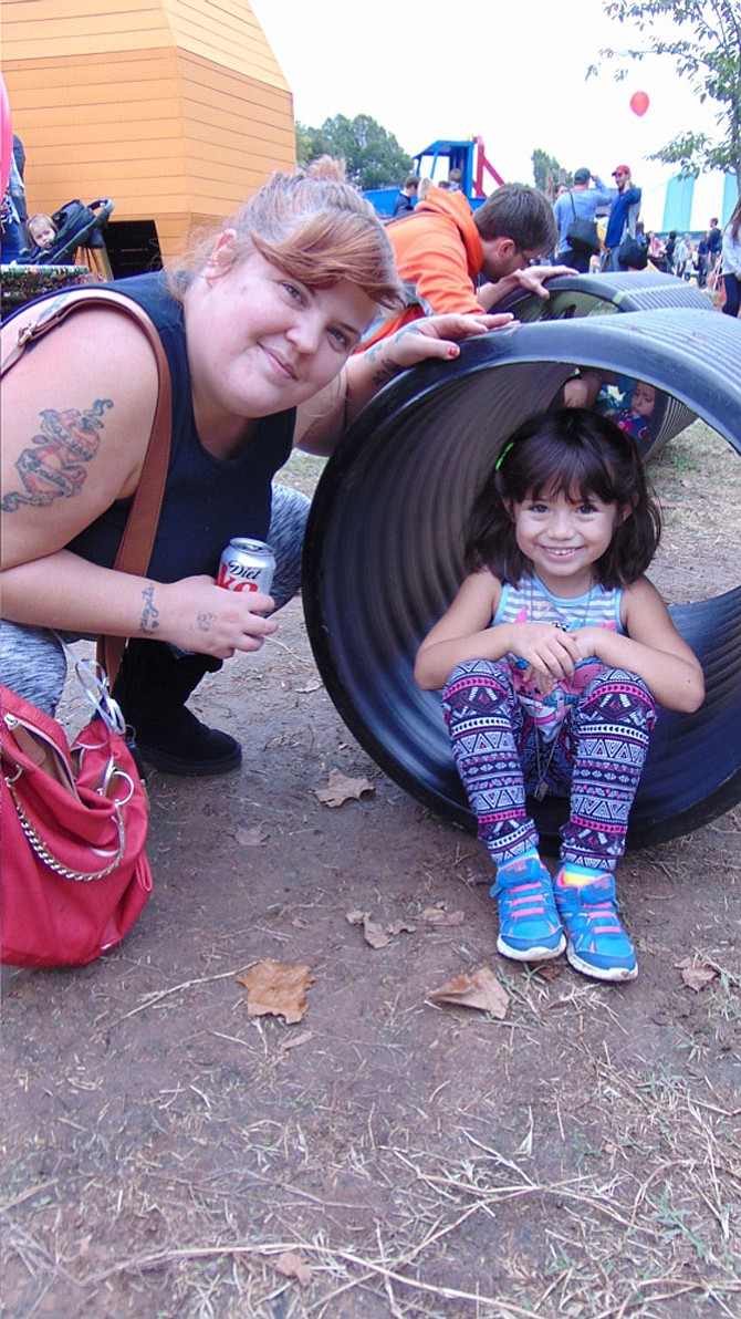 Alyssa and Arrianna Mizuki of Springfield play on the tumbling tubes at Burke Nursery and Garden Centre's 23rd annual Pumpkin Playground.