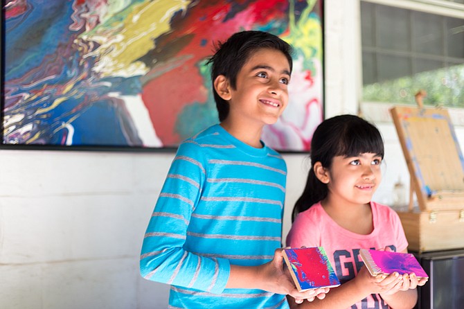 Brother and sister, Shawn Sidhu, 9, and Sarena Sidhu, 6, with their spin-art that they made with the help of Great Falls artist, Linda Cameron, for the Great Falls Studio Arts Tour Saturday. 
