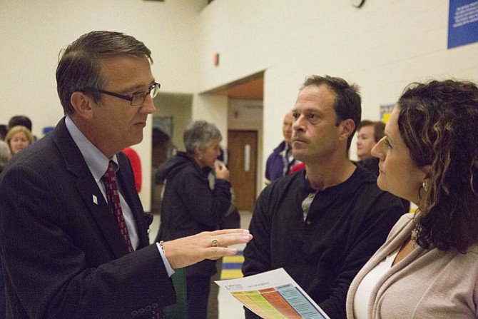 Parents Basil (center) and Elizabeth Sakati of Reston talk to FCPS Superintendent Scott Brabrand (left) about which high school their two children will eventually attend and if they have options to select other high schools in their region. Their children, 11- and 12-year-olds, attend Buzz Aldrin Elementary School in Reston, and will eventually feed into Herndon High School when they finish middle school.
