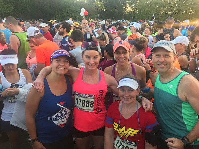 Kat Gruber, Brooke Curran, Andrea Stoddard, Leah Ramirez and Glen Stone pose for a RunningBrooke team photo at the finish line of the Marine Corps Marathon. This was Curran’s 111st marathon raising money for several Alexandria children’s charities. She finished the course in 3:58:50.
