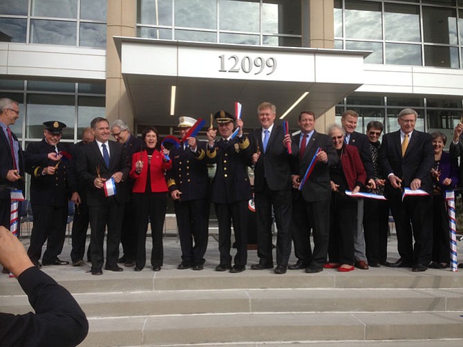 All hands on the golden scissors to open the new Public Safety Headquarters.