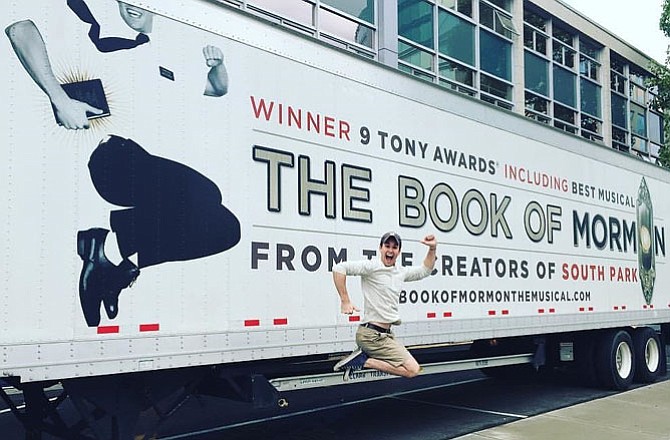 Jumping for joy, Kevin Clay mimics the image on his show’s advertisement in Vancouver, B.C.