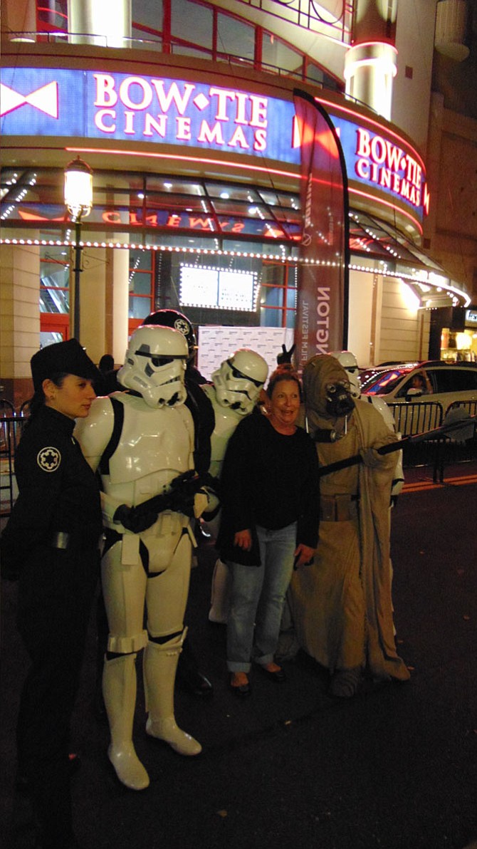 Georgia Cassedy of Reston with the all-volunteer 501st Legion dressed as "Star Wars" characters at the film premiere of "Clive Davis: The Soundtrack of Our Lives," during the Washington West Film Festival at the Bow Tie Cinemas at Reston Town Center.
