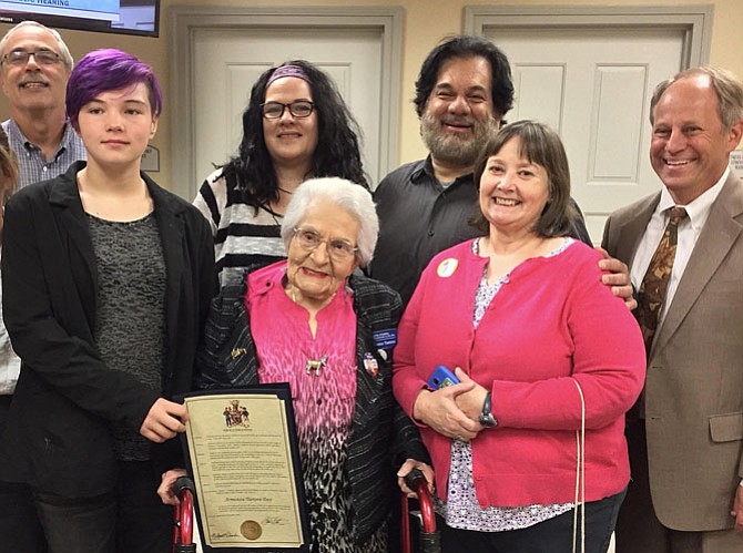 Friends and family – including Armistice Turtora’s son Jim (in beard), who lived with her in Fairfax – pose with the proclamation naming Nov. 11, 2016 as Armistice Turtora Day in the City of Fairfax. 