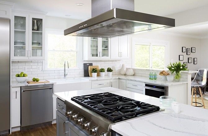 This kitchen by Case Design/Remodeling, Inc. includes a cooktop with a 36” island range hood.