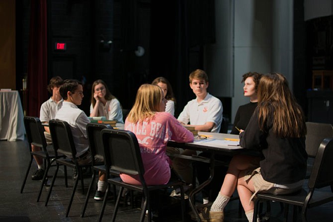 Bishop Ireton students in rehearsal for "Twelve Angry Jurors" (from left): Kevin McNerney (Juror # 8), Jake Carlo (Juror # 10), Kathleen McNerney (Juror # 7), Anna Johnson (Juror # 12), Roxanne Fisher (Juror # 5), Andrew Holland (Juror # 4), Olivia Hays (Juror # 3), and Emily Graham (Foreman).