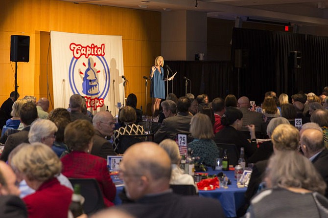 UCM Executive Director Alison DeCourcey welcomes more than 350 guests to the 26th annual Capitol Steps Benefit for UCM on Nov. 5 at the US Patent & Trademark Office.