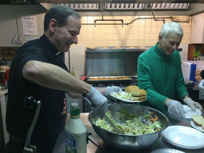 The Most Rev. Michael Burbidge, bishop of the Catholic Diocese of Arlington, serves the poor at Christ House, an operation of Catholic Charities.