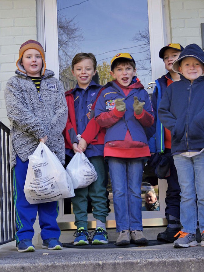 Cub Scout Troop 641 volunteers, in 23-degree temperature, collect food as part of the annual national Scouting for Food drive. This is their second year of participating as part of the Scout Slogan "to do a good deed daily." Their collection area covers Albermarle, Chesterbrook and Glebe Road. 
