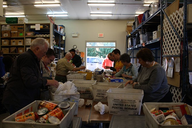 Inside ECHO, the food on Scouts for Food Drive day are piling up.