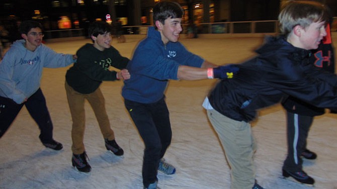 Forming a train at the Reston Town Center Ice Skating Pavilion are McKean McConnell, 15, of Great Falls; Marc James-Finel, 15, of McLean; Thomas Ryan, 15, of Great Falls; and Aidan Kenny, 15, of Great Falls.