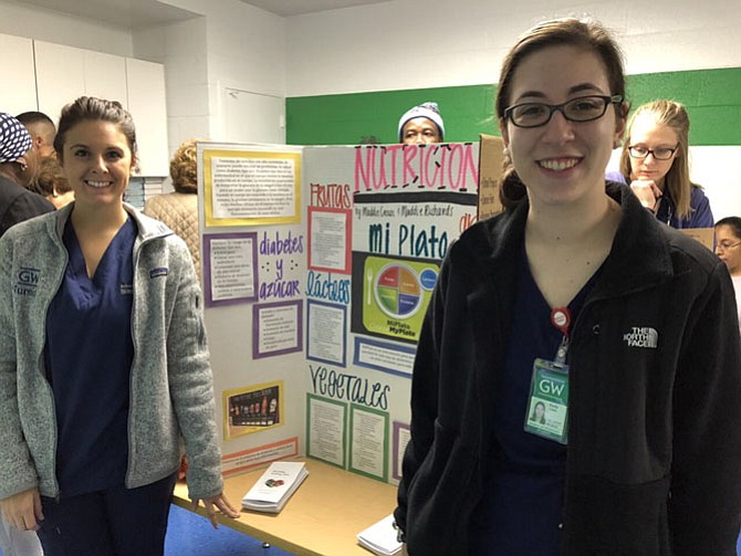 From left: George Washington School of Nursing students Brittni Dipatrizio and Emily Cohen prepare to volunteer at the Share, Inc., Health Fair held Wednesday, Nov. 8, in the basement of the McLean Baptist Church located at 1367 Chain Bridge Road.