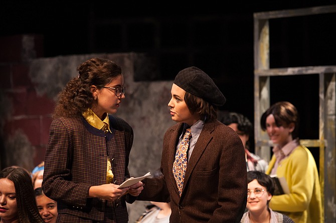 From left: Alex Raposo as Sylvia Barrett, Mallie Moore as Paul Barringer; background from left: Caroline Potter, Neha Sinha, Anna Blackmon, Alika Mattheisen in the Madeira School production of “Up the Down Staircase.”
