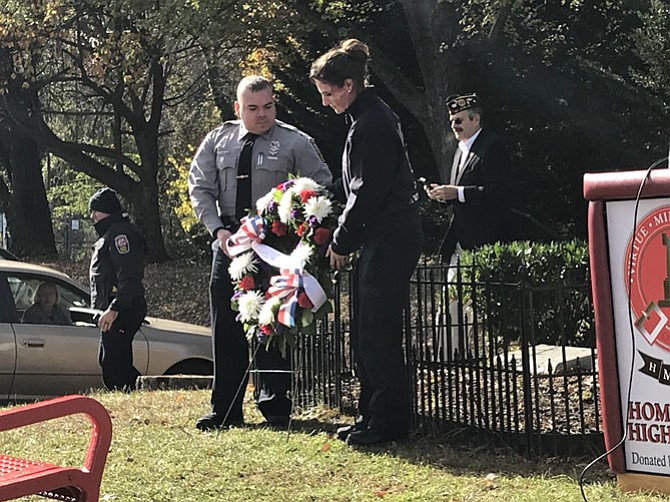 Rafael Orellana of Fairfax and Tavia Kauffman of McLean lay the wreath at the Veterans Day Memorial service. 