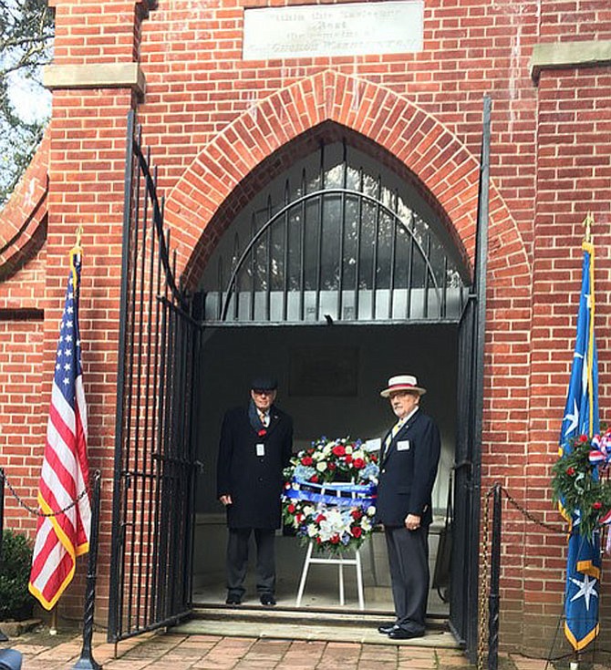 Cdr. Joseph Famme (left) and Col. John Bridge present the wreath at the tomb.
