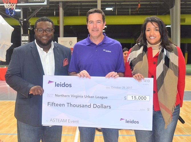 Signature Sponsor Leidos presents a $15,000 check to Northern Virginia Urban League for the expo, from left: Jamil Smart, Smart Learning Solutions President/CEO; Tim Reardon, Leidos President, Defense & Intelligence Group; and Tracey Walker, NVUL Board Chair.