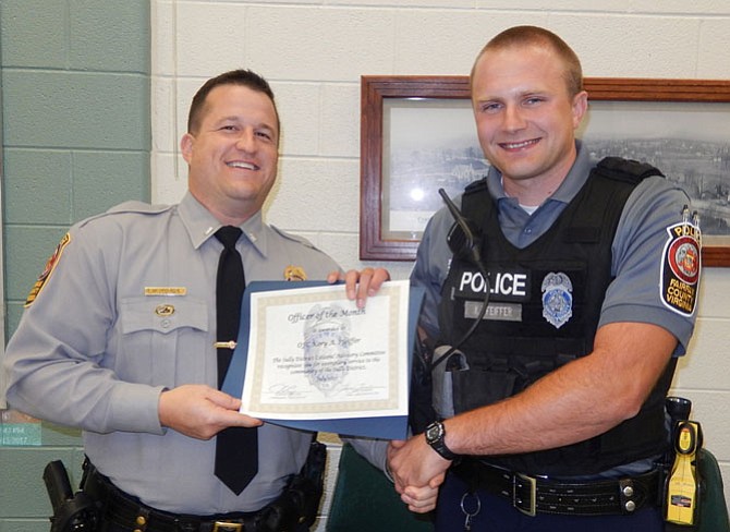 Lt. Ryan Morgan (left) presents the Officer of the Month award to PFC Kory A. Pfeiffer.