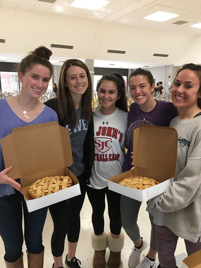 Bullis School seniors Samantha Durham, Jessica Ravitch, Kate Morris, Sophie McIntyre, and Rachel Gordon show off two of the pies students baked Saturday.