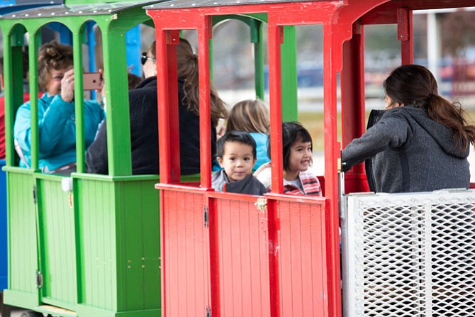 Devin Nguyen, 2 and a half, rides the Turkey train with his mother Brenda Nguyen and sister Sofie, four years old, at Lake Fairfax Park in Reston Saturday.