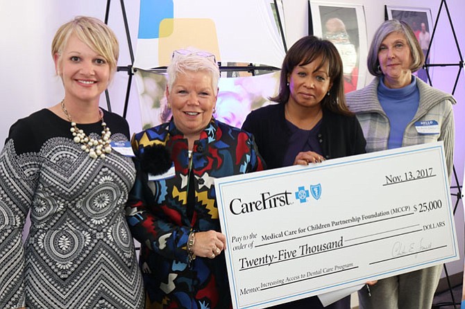 MCCP’s check presentation. From left: Penny Bladich, board chair, MCCP; Marcia Twomey, Executive Director, MCCP; Maria Harris Tildon, Senior Vice President of Public Policy and Community Affairs, CareFirst; and, Andrea Lomrantz, Director of Family Services, Fairfax County.
