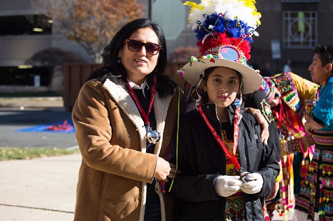 From left: Ayda Lopez and Alejandra Villareal pictured, as members of Bolivian Tinkus San Simon get ready to perform at Reston Town Center’s 27th annual Holiday Parade on Friday.