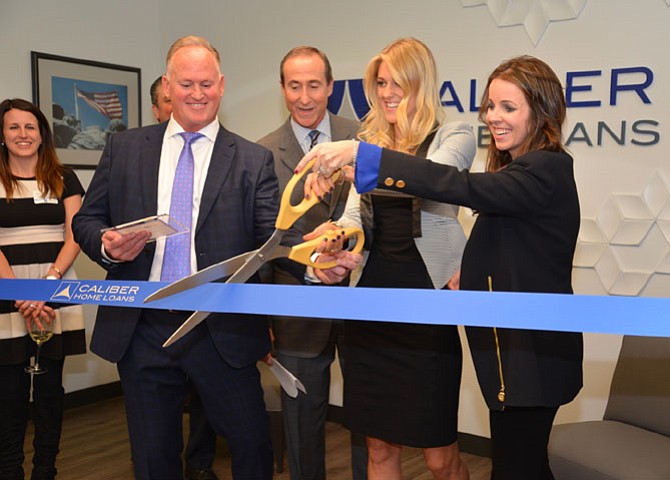 Caliber Reston Branch Manager Rob Molthen, Greater Reston Chamber of Commerce CEO Mark Ingrao, Lindsay Simmons and Katie Simmons Hickey of the Simmons Team, cut the ribbon on their new offices at 12010 Sunset Hills in Reston.